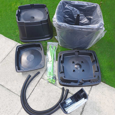 black water butt kit showing parts of water butt ready to be assembled including water butt stand and rainwater diverter